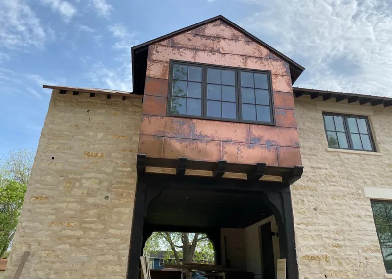 Copper metal panel facade on a stone building for Metal Roof Coating in Countryside